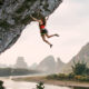 Woman hanging from a cliff.
